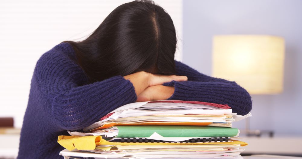 girl with head down being overwhelmed by math competition preparation